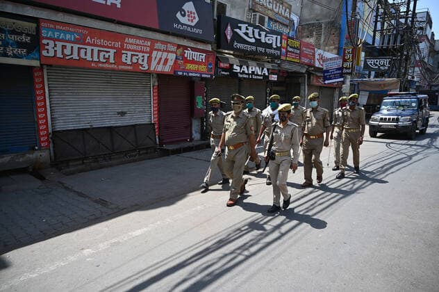 April 18, 2021, Allahabad, Uttar Pradesh, India: Prayagraj: Police personnel walk past Closed shop on first day of weekly lockdown during COVID-19 spread in Prayagraj on Sunday, April 18, 2021. Allahabad India - ZUMAv115 20210418_zap_v115_002 Copyright: xPrabhatxKumarxVermax