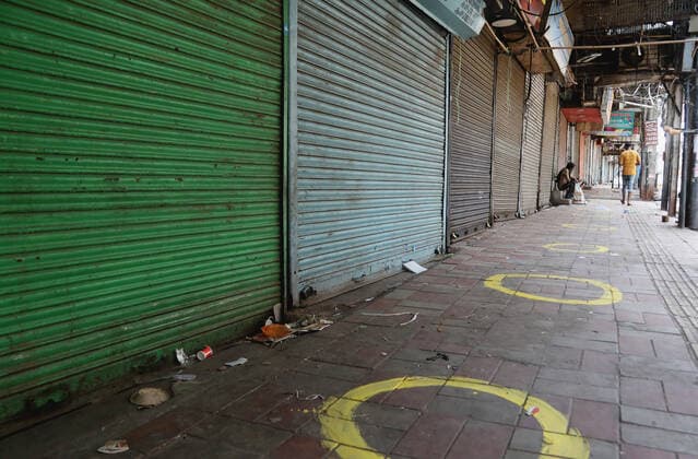 April 18, 2021, New Delhi, India: Social distance marks seen outside a closed shop at the Sadar Bazar wholesale market during the weekend lockdown imposed by the State government to curb again spike of coronavirus (Covid-19) cases. .Only essential services will be exempted from the lockdown, India reported 264,500 new Covid-19 infection cases, 1,501 deaths and 138,423 discharges in last 24 hours. New Delhi India - ZUMAs197 20210418_zaa_s197_068 Copyright: xNaveenxSharmax
