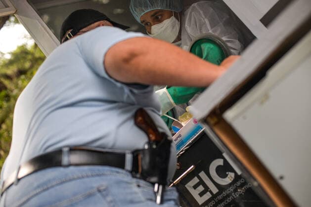 April 19, 2021, San Salvador, El Salvador: A man with a holstered gun is tested for Covid-19 at a mobile testing booth at the Salvadoran National University. San Salvador El Salvador - ZUMAs197 20210419_zaa_s197_097 Copyright: xCamiloxFreedmanx