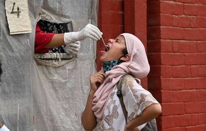 COVID-19 outbreak in India A health worker taking swab sample at a collection centre in Prayagraj. Allahabad Uttar Pradesh India Copyright: PrabhatxKumarxVerma