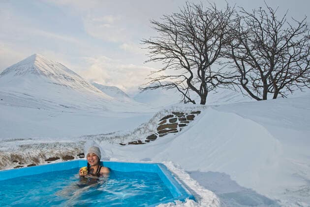 Woman enjoying hot tub at ski lodge in Iceland Dalvik, Iceland CR_THHE210422B-725015-01 ,model released, Symbolfoto ,property released