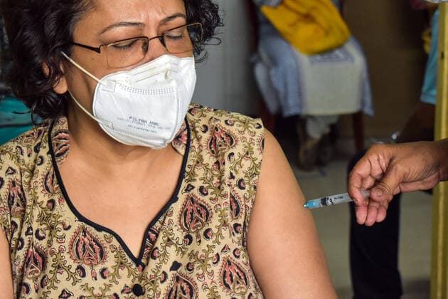Vaccine crisis in Kolkata A woman receives a dose of Covaxin (Vaccine of Corona Virus) inside West Bengal state Health Vaccination centre in Kolkata. Kolkata West Bengal India Copyright: SudiptaxDas