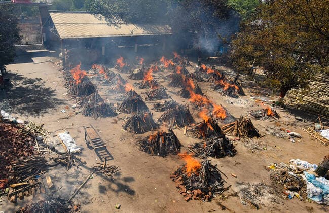 NEW DELHI, INDIA APRIL 24: Multiple funeral pyres of people who died of Covid-19 burning simultaneously at Gazipur crematorium on April 24, 2021 in New Delhi, India. (Photo by Amal KS Hindustan Times ) Covid Death Toll Continues To Rise In India