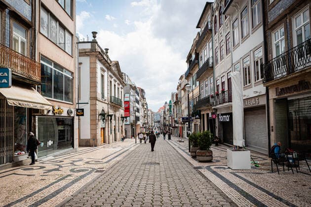April 24, 2021, Porto, Portugal: People walk on a semi deserted Rua de Santa Catarina street..Portugal is at the 3rd stage of the deconfinement plan but stores, restaurants and coffee shops are still closed on the weekend during the afternoon. Porto Portugal - ZUMAs197 20210424_zaa_s197_214 Copyright: xTeresaxNunesx