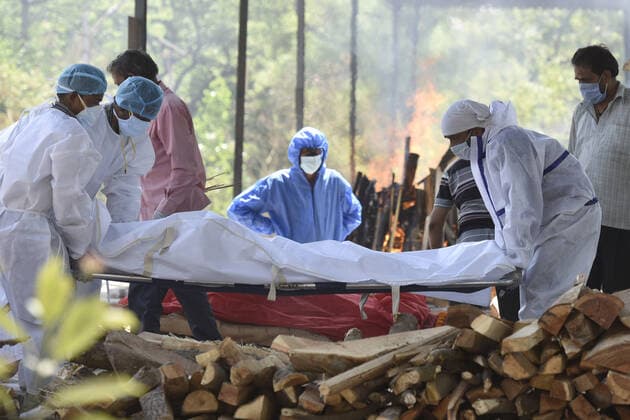 NOIDA, INDIA APRIL 25: The body of a person who died of Covid-19 being laid for cremation at Sector 94, on April 25, 2021 in Noida, India. (Photo by Sunil Ghosh Hindustan Times ) Covid Death Toll Continues To Rise In India
