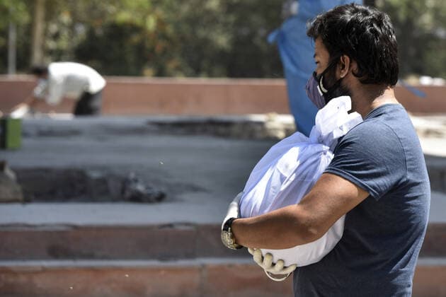 NOIDA, INDIA APRIL 25: The relative of a person who died of Covid-19 at the crematorium, at Sector 94, on April 25, 2021 in Noida, India. (Photo by Sunil Ghosh Hindustan Times ) Covid Death Toll Continues To Rise In India