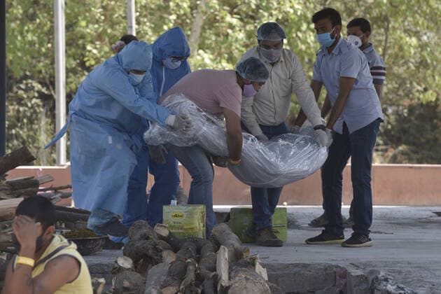 NOIDA, INDIA APRIL 25: The body of a person who died of Covid-19 being laid for cremation at Sector 94, on April 25, 2021 in Noida, India. (Photo by Sunil Ghosh Hindustan Times ) Covid Death Toll Continues To Rise In India