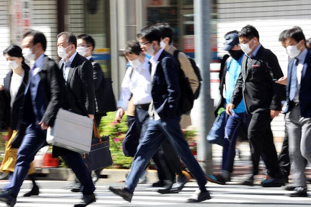 April 26, 2021, Tokyo, Japan - People walk to their offices amid outbreak of the new coronavirus in Tokyo on Monday, April 26, 2021. Tokyo, Osaka, Kyoto and Hyogo prefecture entered a new state of emergency for COVID-19 on April 25 through May 11.  (159071262)