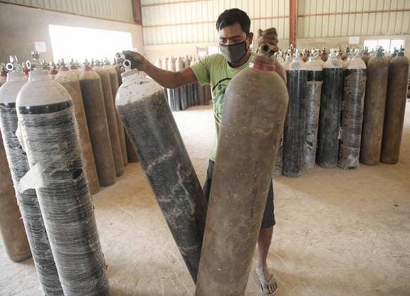 Workers fill oxygen cylinders to supply to hospitals for COVID-19 patients in an industrial area, outskirts of Agartala  AbhisekxSahax xLexPictorium LePictorium_0245357