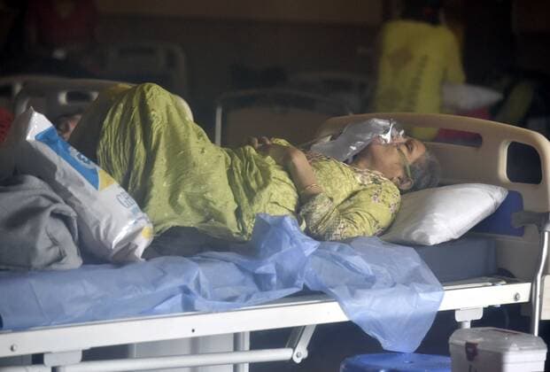 NEW DELHI, INDIA - APRIL 26: Patients rest at the Covid-19 Care Centre, for a temporary Covid Care Centre set up at Shehnai Banquet Hall attached to LNJP Hospital, on April 26, 2021 in New Delhi, India. India has registered 2,762 new deaths and 319,315 new infections recording more than 300,000 daily Covid-19 cases for the fifth day in a row, reaching a new record peak. (Photo by Sonu Mehta Hindustan Times) Temporary Covid-19 Care Centre In Delhi