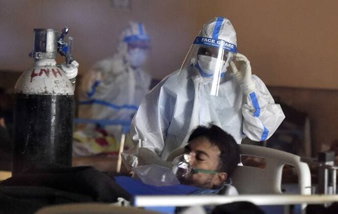 NEW DELHI, INDIA - APRIL 26: Patients rest at the Covid-19 Care Centre, for a temporary Covid Care Centre set up at Shehnai Banquet Hall attached to LNJP Hospital, on April 26, 2021 in New Delhi, India. India has registered 2,762 new deaths and 319,315 new infections recording more than 300,000 daily Covid-19 cases for the fifth day in a row, reaching a new record peak. (Photo by Sonu Mehta Hindustan Times) Temporary Covid-19 Care Centre In Delhi