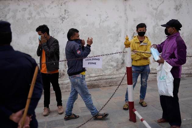 April 27, 2021, Kathmandu, Nepal: A man buys a face mask after Police detain them for not wearing the masks as the spread of coronavirus disease increases owing to the second wave of the virus in Kathmandu, Nepal on Tuesday, April 27, 2021. Kathmandu Nepal - ZUMAg200 20210427_zap_g200_002 Copyright: xSkandaxGautamx