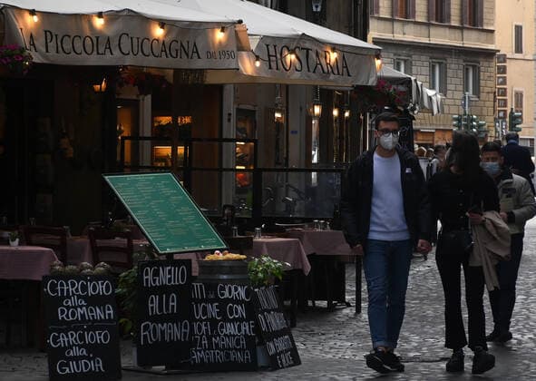 (210426) -- ROME, April 26, 2021 -- People walk past a restaurant in Rome, Italy, on April 26, 2021. Italy took a first decisive step toward a post-pandemic phase on Monday, the first day of reopening amid decreasing coronavirus cases. (Photo by Xinhua) ITALY-ROME-COVID-19-REOPENING ElisaxLingria 