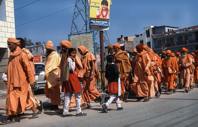 13.03.2010, Haridwar, Uttarakhand, Indien, Asien - Eine Gruppe maennlicher Pilger in orangefarbenen Gewaendern auf ihrem Weg zum Har Ki Pauri Ghat am Ufer des heiligen Ganges waehrend des religioesen Hindufestes Purna Kumbh Mela.