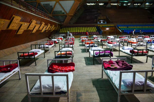 April 27, 2021, Srinagar, India: Workers set up beds during preparations to convert Sher-e-Kashmir Indoor Stadium into a makeshift quarantine center following the surge in coronavirus cases in Srinagar..A COVID-19 emergency center has been set up at Indoor Stadium in Srinagar in view of a surge in Coronavirus infections in the valley officials said. Meanwhile, India reported a total of 323,023 new coronavirus cases, 2,771 related deaths, and 251,827 recoveries in the last 24 hours. Srinagar India - ZUMAs197 20210427_zaa_s197_006 Copyright: xSaqibxMajeedx