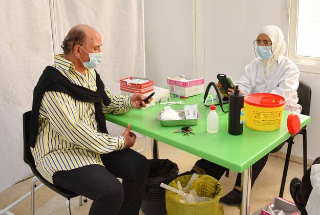 April 27, 2021, Tunis, Tunisia: A man waits to receive a dose of the Pfizer-BioNTech COVID-19 vaccine at Ariana Youth Center as vaccination centers across the country experience an influx of registrations during Ramadan. Tunis Tunisia - ZUMAs197 20210427_zaa_s197_022 Copyright: xJdidixWassimx