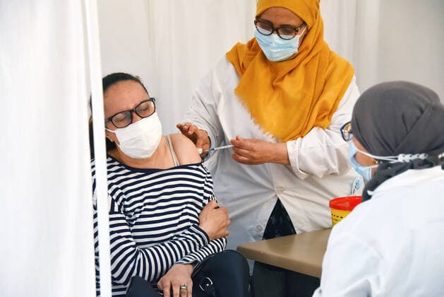 April 27, 2021, Tunis, Tunisia: A woman receives a dose of the Pfizer-BioNTech COVID-19 vaccine at Ariana Youth Center as vaccination centers across the country experience an influx of registrations during Ramadan. Tunis Tunisia - ZUMAs197 20210427_zaa_s197_024 Copyright: xJdidixWassimx