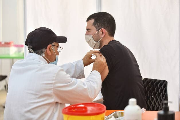 April 27, 2021, Tunis, Tunisia: A man receives a dose of the Pfizer-BioNTech COVID-19 vaccine at Ariana Youth Center as vaccination centers across the country experience an influx of registrations during Ramadan. Tunis Tunisia - ZUMAs197 20210427_zaa_s197_025 Copyright: xJdidixWassimx