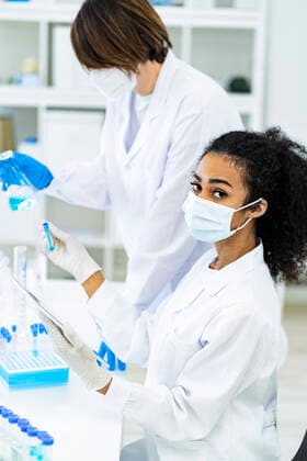 Female researcher working with coworker together in laboratory model released Symbolfoto property released GIOF11866