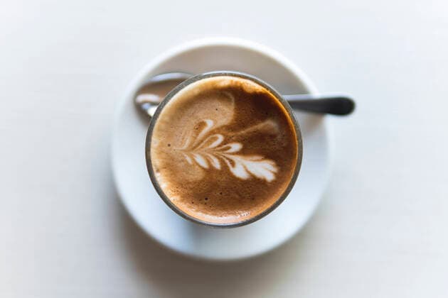 Cappuccino on table at coffee shop property released JAQF00453