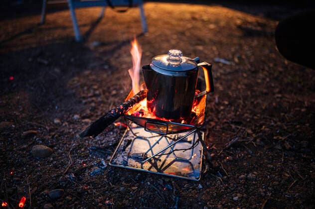Kettle on camping stove at night JCMF01934