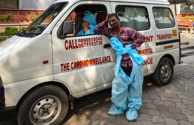 NEW DELHI, INDIA - APRIL 27: A relative of a Covid-19 victim waits for the funeral, at Nigambodh Ghat on April 27, 2021 in New Delhi, India. (Photo by Amal KS Hindustan Times) Covid Death Toll Continues To Rise In India