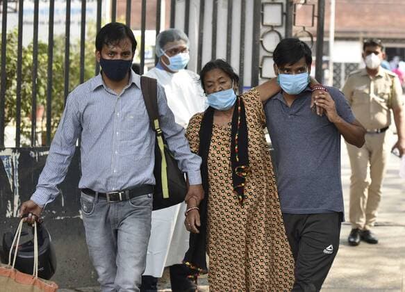 NEW DELHI, INDIA - APRIL 27: A Covid patient with attended leave after treatment the Covid-19 ward at Lok Nayak Jai Prakash (LNJP) on April 27, 2021 in New Delhi, India. As Covid-19 cases continued to surge in Delhi with over 98,264 active cases people are struggling to get hospital beds, ventilators, oxygen cylinders, injections and medicines with the health infrastructure in the state almost stretched to its limit. (Photo by Sonu Mehta Hindustan Times) As COVID Cases Surge, Indian Hospitals Struggle With Shortage Of Beds