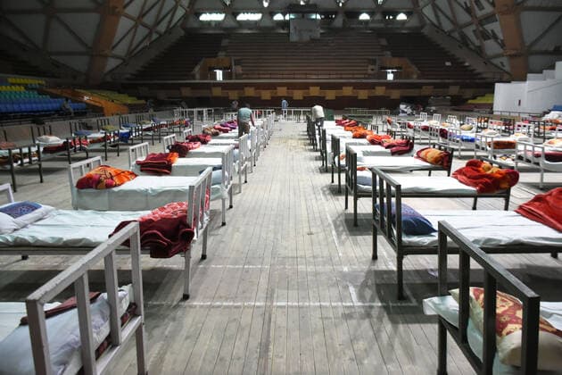 April 27, 2021: workers set up beds at a makeshift Covid-19 hospital cum containment in Srinagar, Indian Administered Kashmir on 27 April 2021. Authorities have turned Sher E Kashmir indoor Stadium into containment centre after the rise in Covid-19 cases in Jammu and kashmir. - ZUMAd99_ 20210427_zap_d99_035 Copyright: xMuzamilxMattoox