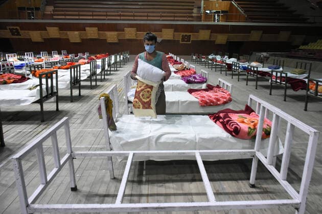 April 27, 2021: A worker sets up beds at a makeshift Covid-19 hospital cum containment in Srinagar, Indian Administered Kashmir on 27 April 2021. Authorities have turned Sher E Kashmir indoor Stadium into containment centre after the rise in Covid-19 cases in Jammu and kashmir. - ZUMAd99_ 20210427_zap_d99_041 Copyright: xMuzamilxMattoox