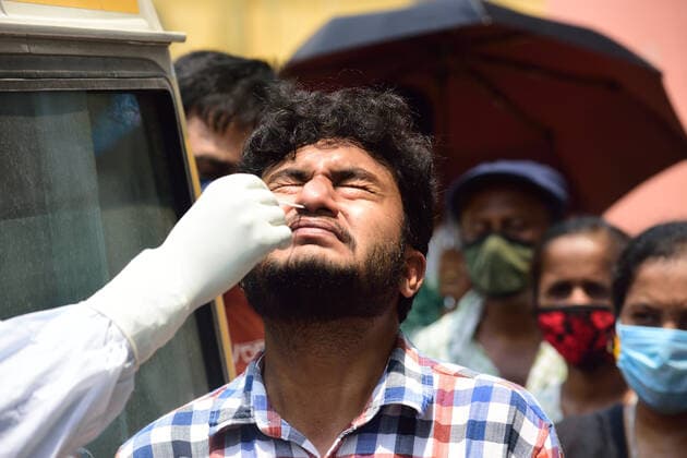 April 28, 2021, Kolkata, West Bengal, India: A healthcare worker collects swab samples from a man for RTPCR covid 19 tests..There has been a scarcity of hospital beds reported in Kolkata as well as other Indian states along with medical oxygen. Kolkata India - ZUMAs197 20210428_zaa_s197_015 Copyright: xSumitxSanyalx