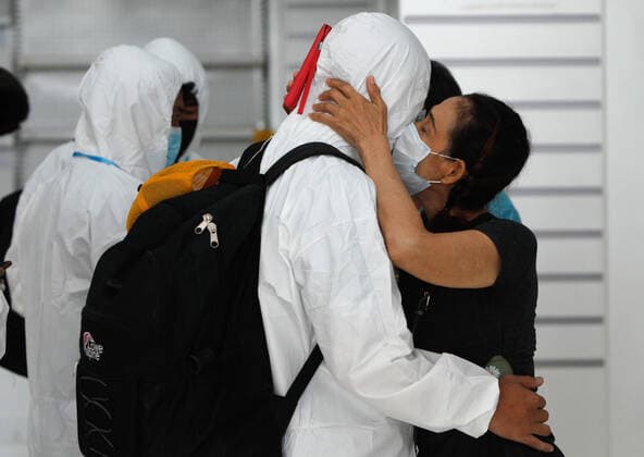April 28, 2021, Bangkok, Thailand: A passenger wearing personal protective equipment suite (PPE) hugs his mother before departing at Suvarnabhumi airport..Ministry of Public Health and the Airport Operation Centre set up a new vaccination centre to remedy the Covid 19 emergency situation and efficiency of vaccination for aviation-related personnel. Bangkok Thailand - ZUMAs197 20210428_zaa_s197_040 Copyright: xChaiwatxSubprasomx