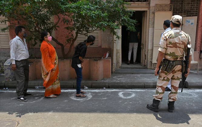 India: 8th Phase of Polling at West Bengal Voters are waiting with maintaining social distance and proper use of Face Mask before enter in Polling Booth at Kolkata. Kolkata India Copyright: SuraranjanxNandi