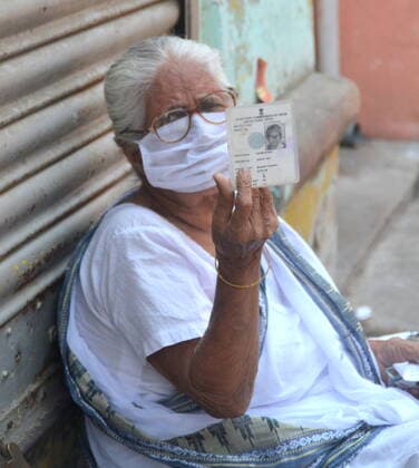 India: Last Phase of voting at West Bengal Assembly Election 2021 A Senior citizen Voter showing her Voter Identity Card before cast her voting right in Voting booth. Calcutta West Bengal India Copyright: AnubrataxMondal