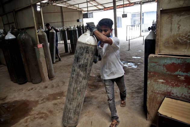 (210429) -- NARAYANGANJ, April 29, 2021 -- A worker prepares to load an oxygen cylinder onto a truck at a refilling station in Narayanganj on the outskirts of Bangladesh capital Dhaka, April 29, 2021. Workers at oxygen refilling stations including the one in Narayanganj are now working overtime to meet the growing demand on hospitals. BANGLADESH-NARAYANGANJ-COVID-19-OXYGEN CYLINDERS Salim 