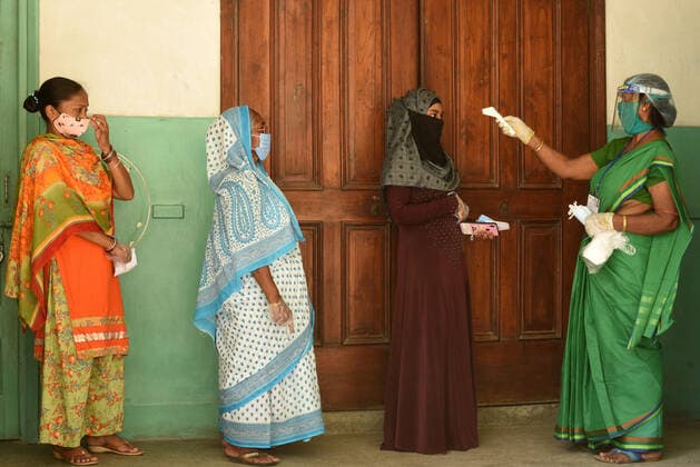 KOLKATA, INDIA - APRIL 29: Voters being thermal screened while in a queue to cast vote during the eighth phase of the West Bengal Assembly Election, at Loreto Convent Entally School on April 29, 2021 in Kolkata, India. Sealing the fate of West Bengal, the last of the 8-phase state elections is currently underway with 35 seats up for grabs. Results for all 294 seats will be announced on May 2. (Photo by Samir Jana Hindustan Times) Voting For Eight Phase Of West Bengal Assembly Elections