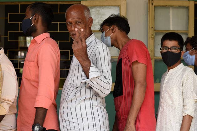 KOLKATA, INDIA - APRIL 29: Voters flouting social distancin norms and some not wearing face masks while in a queue to cast vote during the eighth phase of the West Bengal Assembly Election, at Loreto Convent Entally School on April 29, 2021 in Kolkata, India. Sealing the fate of West Bengal, the last of the 8-phase state elections is currently underway with 35 seats up for grabs. Results for all 294 seats will be announced on May 2. (Photo by Samir Jana Hindustan Times) Voting For Eight Phase Of West Bengal Assembly Elections