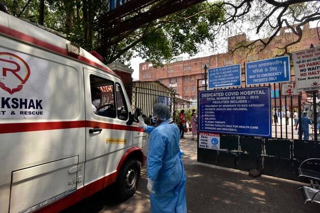 NEW DELHI, INDIA - APRIL 29: An ambulance waiting for admission outside Lok Nayak Jai Prakash (LNJP) hospital, on April 29, 2021 in New Delhi, India. As Covid-19 cases continued to surge in Delhi with over 97,977 active cases people are struggling to get hospital beds, ventilators, oxygen cylinders, injections and medicines with the health infrastructure in the state almost stretched to its limit. (Photo by Sanjeev Verma Hindustan Times) As COVID Cases Surge, Indian Hospitals Struggle With Shortage Of Beds