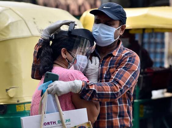 NEW DELHI, INDIA - APRIL 29: A woman being consoled after the hospital turned away her father from admission into the Covid-19 ward at Lok Nayak Jai Prakash (LNJP) Hospital, on April 29, 2021 in New Delhi, India. As Covid-19 cases continued to surge in Delhi with over 97,977 active cases people are struggling to get hospital beds, ventilators, oxygen cylinders, injections and medicines with the health infrastructure in the state almost stretched to its limit. (Photo by Sanjeev Verma Hindustan Times) As COVID Cases Surge, Indian Hospitals Struggle With Shortage Of Beds