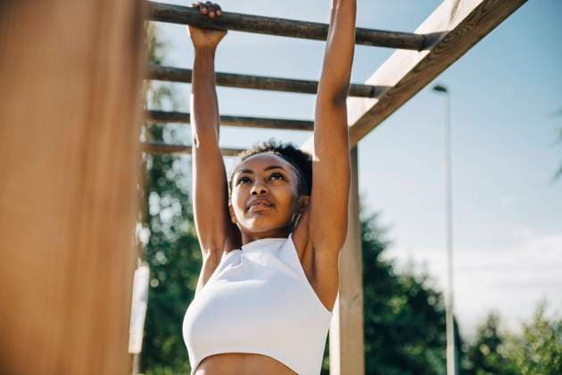 IMAGO Creative, Lifestyle, Tik Tok-Trend thatgirl Female athlete hanging on monkey bar in park Sweden, Stockholm, model released Copyright: xMaskotx , MA86132