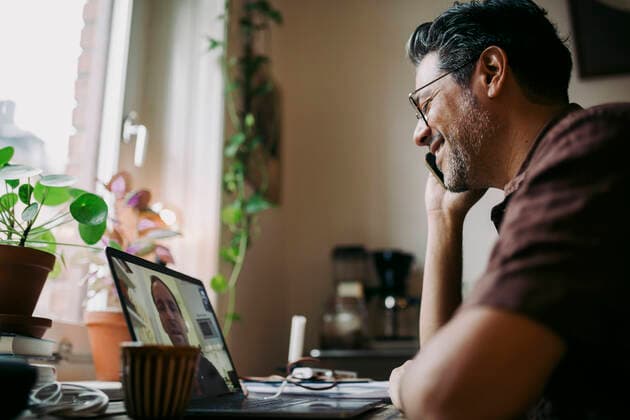 Businessman talking over smart phone during meeting on video call with colleague at home office Sweden, Stockholm, model released, property released Copyright: xMaskotx , MA86229