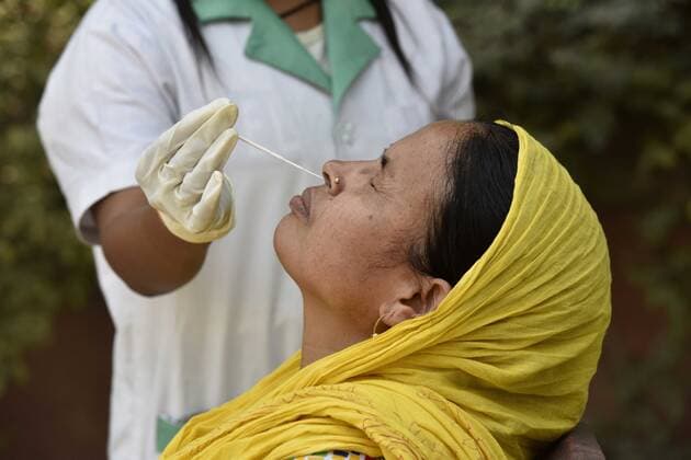 NOIDA, INDIA APRIL 29: A health worker collecting a swab sample for a Covid-19 test, at Bhangel CHC Hospital sector 110, on April 29, 2021 in Noida, India. (Photo by Sunil Ghosh Hindustan Times ) Medical Team Conducts COVID-19 Coronavirus Test