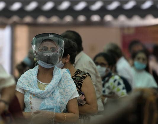 MUMBAI, INDIA ? APRIL 29: Beneficiaries wait in a queue to get vaccinated with a dose of Covid-19 vaccine at BKC Jumbo Covid-19 Vaccination Centre on April 29, 2021 in Mumbai, India. (Photo by Satish Bate Hindustan Times ) COVID-19 Vaccination Drive