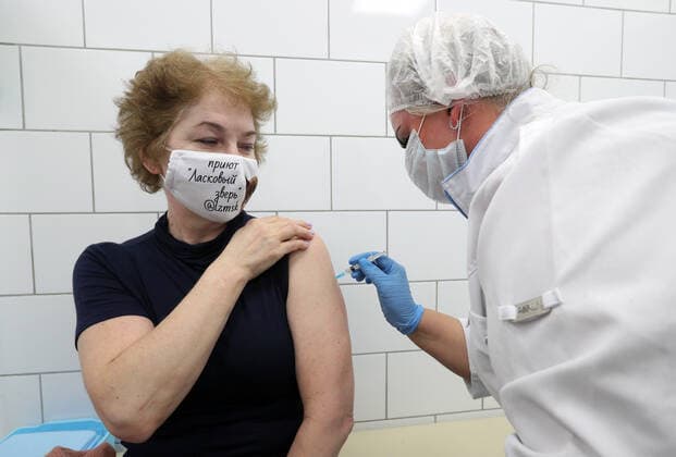 MOSCOW, RUSSIA â€” APRIL 30, 2021: A woman is injected with the Gam-COVID-Vac vaccine (under the brand name of Sputnik V) at a temporary vaccination site in the Globus superstore. A mobile vaccination team is providing vaccines free of charge and without prior sign-up. Since the start of the pandemic, Moscow has confirmed more than 1,092,800 cases of COVID-19. Since the beginning of April, the number of new confirmed cases has been increasing in the Russian capital by more than 1,500 daily. Gavriil Grigorov TASS  TS0FEB22