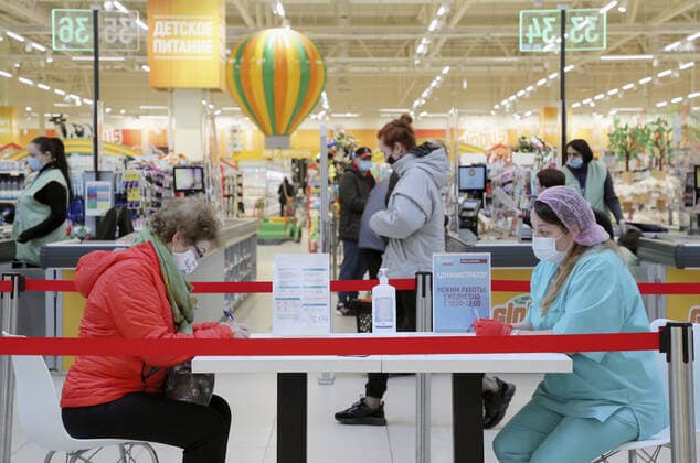 MOSCOW, RUSSIA â€” APRIL 30, 2021: A woman (L) fills in paperwork before receiving the Gam-COVID-Vac vaccine (under the brand name of Sputnik V) at a temporary vaccination site in the Globus superstore. A mobile vaccination team is providing vaccines free of charge and without prior sign-up. Since the start of the pandemic, Moscow has confirmed more than 1,092,800 cases of COVID-19. Since the beginning of April, the number of new confirmed cases has been increasing in the Russian capital by more than 1,500 daily. Gavriil Grigorov TASS  TS0FEB31