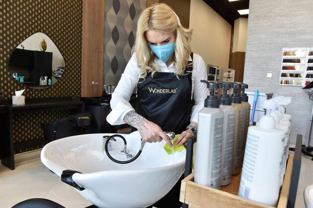A hairdresser Kristyna Humlova prepares her salon in the Futurum shopping mall in Brno, for reopening as further coronavirus lockdown restrictions are lifted in Czech Republic. Hairdressers, cosmetics, massage, animal care and similar services can reopen in Czechia as of May 3 amid the improving coronavirus epidemic situation. (CTKxPhoto VaclavxSalek) CTKPhotoP2021043007187  sal 04