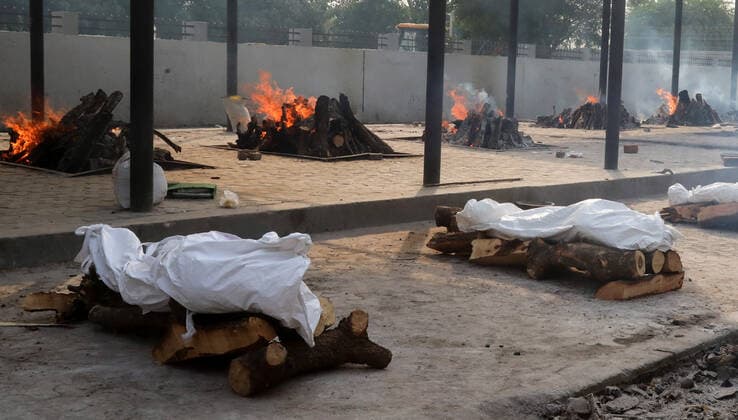 April 30, 2021, New Delhi, India: (EDITORS NOTE: Image depicts death).Bodies of those who lost their life due to the coronavirus Covid-19 disease wait to be cremated during the mass cremation at Dwarka crematorium..The ongoing vaccination drive will open for 18-45 age group from May 01, 2021. India has recorded 386,452 new coronavirus infection cases and 3,498 death in the last 24 hours. New Delhi India - ZUMAs197 20210430_zaa_s197_076 Copyright: xNaveenxSharmax