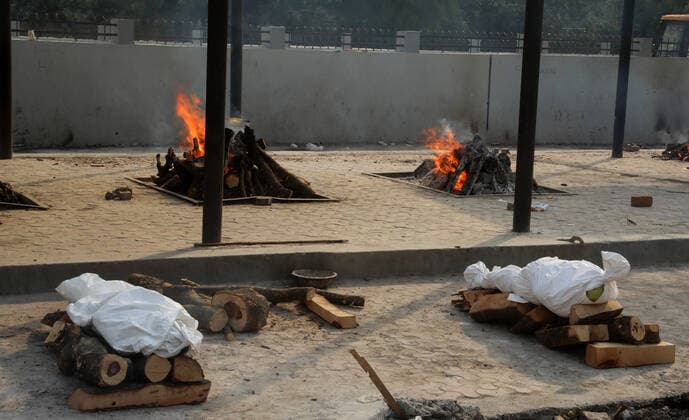 April 30, 2021, New Delhi, India: (EDITORS NOTE: Image depicts death).Bodies of those who lost their life due to the coronavirus Covid-19 disease wait to be cremated during the mass cremation at Dwarka crematorium..The ongoing vaccination drive will open for 18-45 age group from May 01, 2021. India has recorded 386,452 new coronavirus infection cases and 3,498 death in the last 24 hours. New Delhi India - ZUMAs197 20210430_zaa_s197_077 Copyright: xNaveenxSharmax