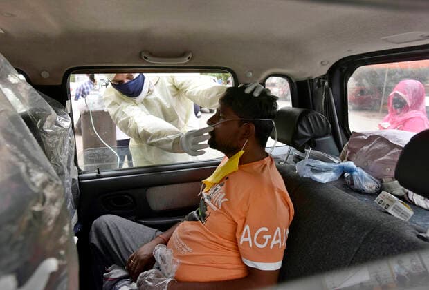 News Bilder des Tages NEW DELHI, INDIA - MAY 2: A Covid-19 patient receiving oxygen support in a car at an Oxygen langar by Gurdwara Damdama Sahib, on May 2, 2021 in New Delhi, India. (Photo by Sanjeev Verma Hindustan Times ) Gurudwara Damdama Sahib Runs Oxygen Langar In Delhi