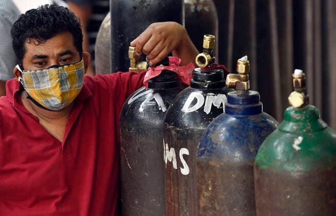 NEW DELHI, INDIA - MAY 2: A rush of people waiting to refill empty oxygen cylinders, at Bhogal Jangpura, on May 2, 2021 in New Delhi, India. (Photo by Sanjeev Verma Hindustan Times ) Daily Life Amid Coronavirus Pandemic In India