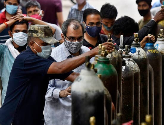 NEW DELHI, INDIA - MAY 2: A rush of people waiting to refill empty oxygen cylinders, at Bhogal Jangpura, on May 2, 2021 in New Delhi, India. (Photo by Sanjeev Verma Hindustan Times ) Daily Life Amid Coronavirus Pandemic In India